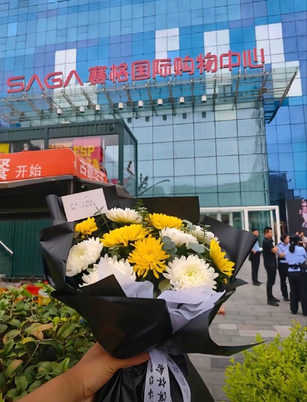 7月2日下午，西安赛格商场，尽管现场有警力驻守并劝阻送花，但仍有不少人陆续来到现场，将鲜花放置在商场附近查看原文📝 引用推文:7月2日，西安赛格小寨天桥周边目前全是警察、城管和保安